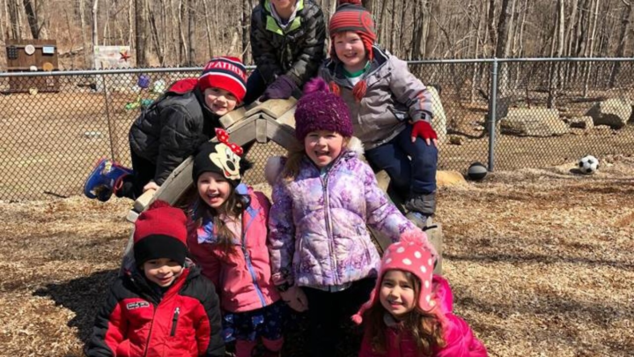 Kindergarteners posing for a photo outside.