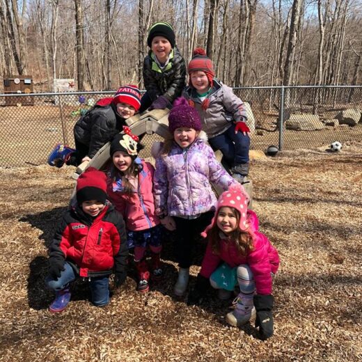 Kindergarteners posing for a photo outside.