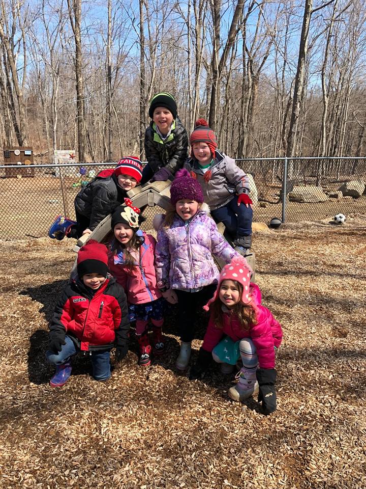 Kindergarteners posing for a photo outside.